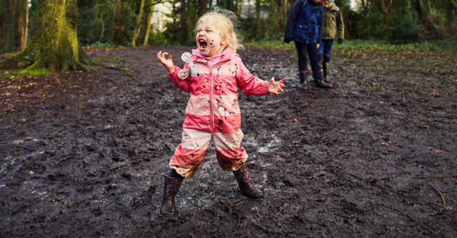 little girl walkng in mud